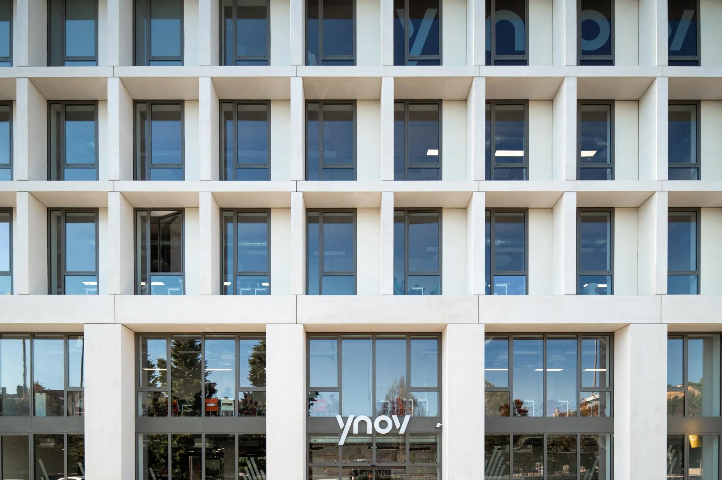 Vue extérieure du bâtiment Ynov Campus, architecture moderne et espaces lumineux.